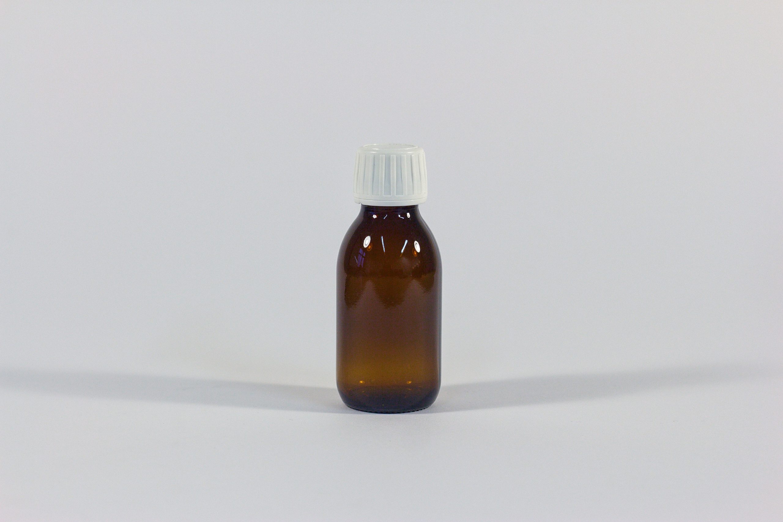 100ml amber glass bottle with white cap. From or glass packging range.