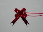 18mm Red pull string ribbons on a white backdrop. Christmas ribbons in different colours.