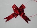 32mm Red pull string ribbon on a white back drop.